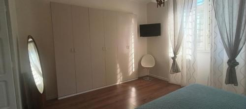 a white room with a tv and a window at Esperia Maison B&b in Montesarchio
