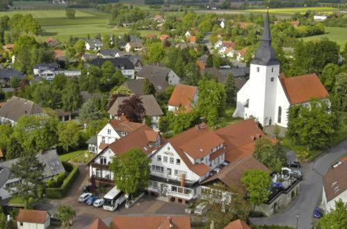 an aerial view of a small town with a church at Schwiizeralp Hotel & Restaurant in Stemwede
