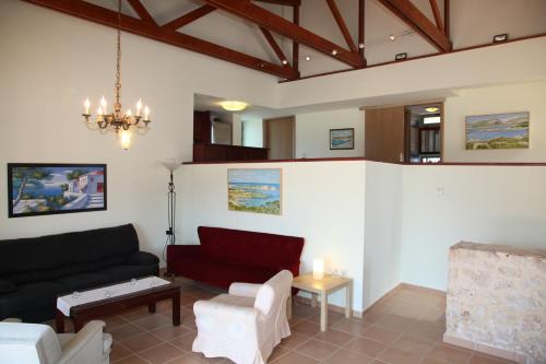 a living room with a couch and a table at Ktima Nikolaos in Arónion