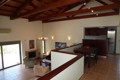 a kitchen and living room with a table and a dining room at Ktima Nikolaos in Arónion