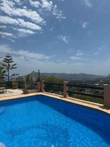 a swimming pool with a view of the mountains at Cozy vacation home in L’Alfàs del Pi