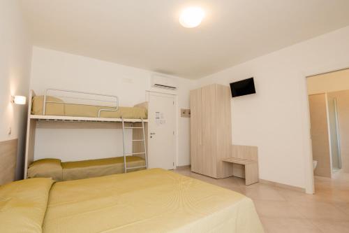 a bedroom with a bed and a tv in it at Hotel Sfinalicchio in Vieste