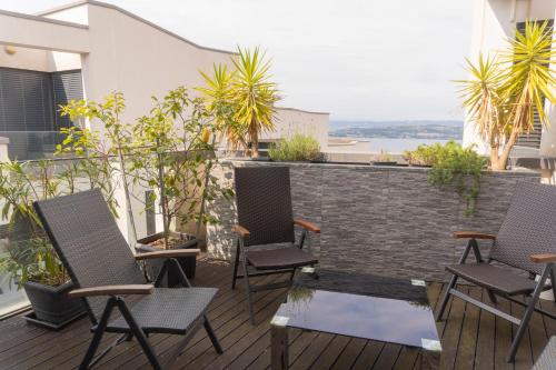 a patio with chairs and a table on a balcony at Apartment Morski cvet in Koper