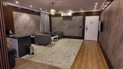 an office with a room with a table and chairs at إيلاف الدمام للوحدات السكنية المخدومة in Dammam