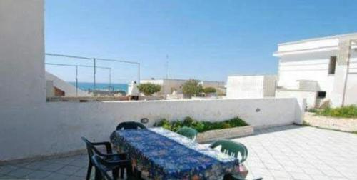 a blue table and chairs sitting on a patio at Casa vacanze in Torre Vado