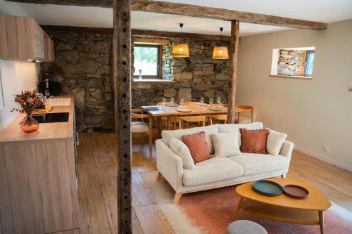 a living room with a couch and a table at Les Granges du Hautacam in Artalens-Souin