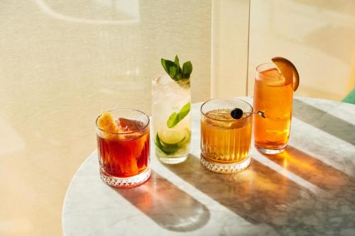 a group of four drinks sitting on a table at The Social Hub Florence Lavagnini in Florence