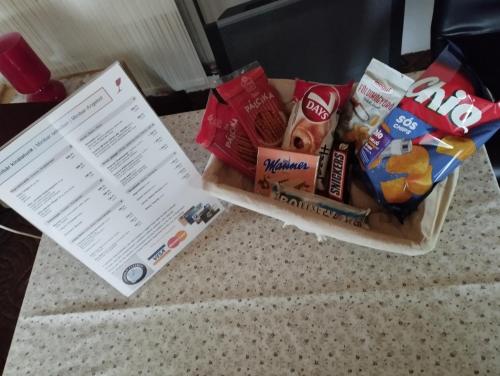 a box of snacks on a counter next to a receipt at Fehérló Vendégház & Restaurant in Bük