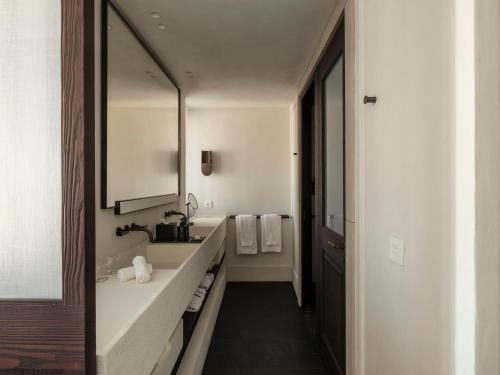 a bathroom with a sink and a mirror at Anandes Hotel in Mýkonos City