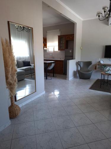 a living room with a mirror and a couch at Titi's home in Ofrínion