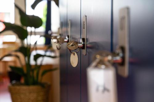 a door with a key on it with a plant at Schanzenstern Altona GmbH in Hamburg