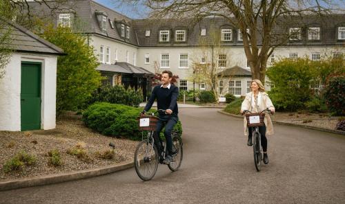 two women riding their bikes down a street at Estate Cabins at Ballygarry in Tralee
