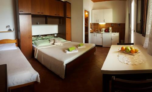 a bedroom with two beds and a table with fruit on it at Apartments Bajo - FREE PARKING in Dubrovnik