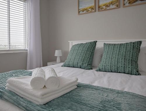 a bedroom with a bed with two towels on it at Mountain and Oceanview at Blouberg in Cape Town