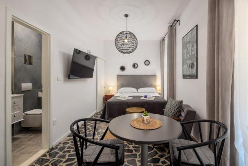a room with a bed and a table and chairs at Villa Mare's in Primošten