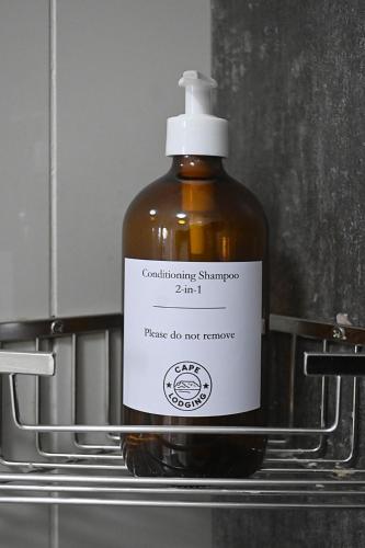 a bottle of contemplation shampoo sitting on a shelf at Mountain and Oceanview at Blouberg in Cape Town