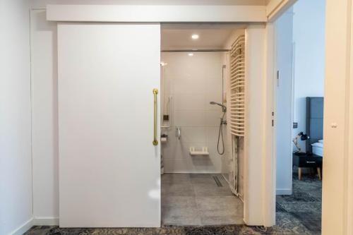 a bathroom with a shower and a glass door at Hotel Nafta Krosno in Krosno