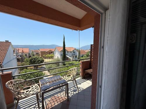 a balcony with a bench and a view at Grand Apartments Scepanovic in Tivat