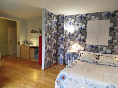 a bedroom with a bed and a painting on the wall at Matrix Garden Apartments in Tallinn