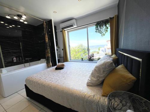 une chambre avec un lit et une grande fenêtre dans l'établissement Luxury Beach Room, à Frontignan