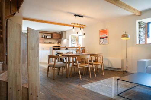 a kitchen and dining room with a table and chairs at Les Granges du Hautacam in Artalens-Souin