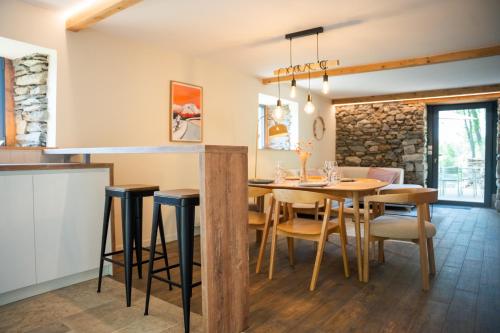 a kitchen and dining room with a table and chairs at Les Granges du Hautacam in Artalens-Souin