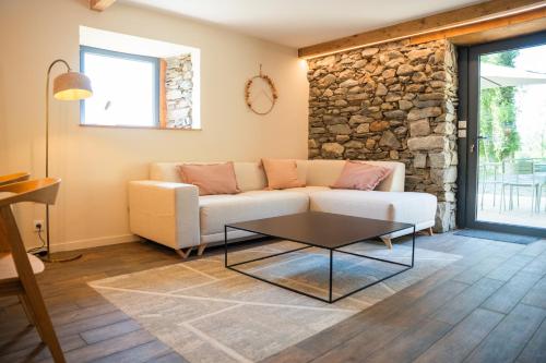 a living room with a couch and a table at Les Granges du Hautacam in Artalens-Souin