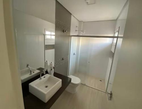 a bathroom with a sink and a toilet and a shower at Pousada Graciosa in Palmas