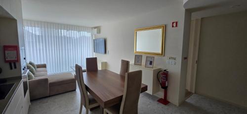 a dining room with a table and a couch at Soldouro Aveiro Station in Aveiro