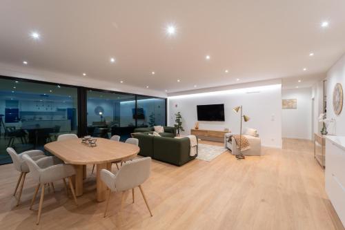 a living room with a table and a couch at Auréa House - 4BR Azores Villa with Ocean View, BBQ & AC in Feteiras