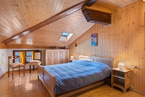 a bedroom with a bed and a wooden ceiling at Casa della Rosina in Bresimo