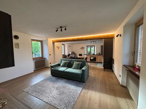 a living room with a couch and a kitchen at Cascina Barbei in Camerana 