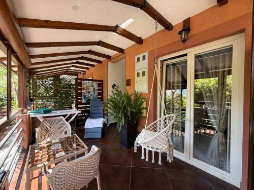 a patio with wicker chairs and a table on a porch at Grand Apartments Scepanovic in Tivat