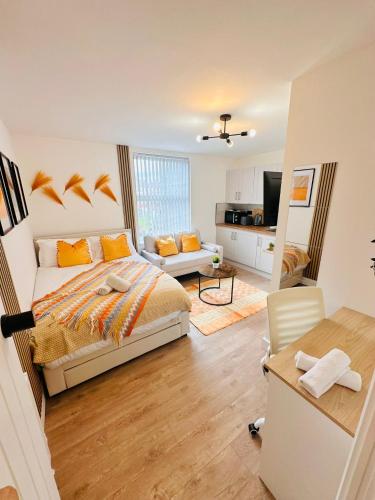 a bedroom with a bed and a living room at R4 - Luxury fully Self-Contained Studio with Private Bathroom and Kitchen in Halesowen