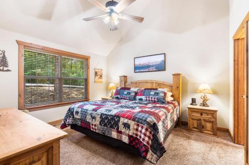 a bedroom with a bed and a ceiling fan at Baldknobber Ridge Escape - West Branson Cabin in Branson West
