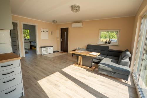 a living room with a couch and a table at Domek wakacyjny Średnia Huta in Warlubie