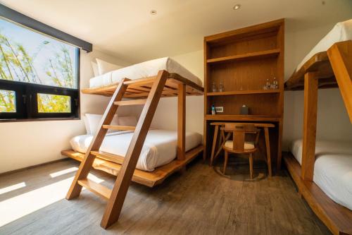 a bedroom with two bunk beds and a desk at The Istana in Uluwatu