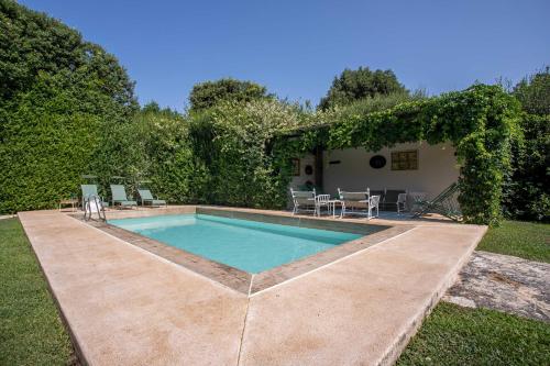 a swimming pool in the backyard of a house at Villaflair - Porto Ercole Pool Villa in Porto Ercole