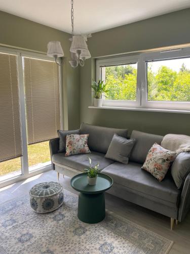 a living room with a couch and two windows at La Jura in Podlesice