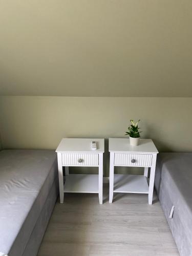 two tables and a bed with a potted plant on it at La Jura in Podlesice
