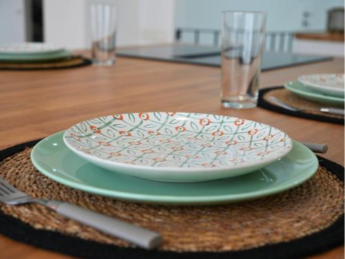 a plate sitting on top of a table at Duplex familiale 3 chambres, 3 salles de bains & jardin à Bruxelles by CYGO Gestion in Brussels