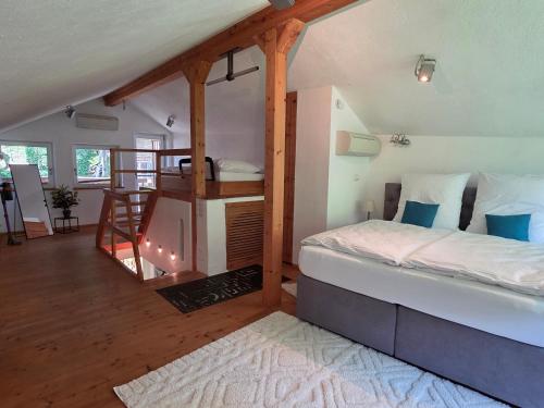 a bedroom with a bed and a staircase in a room at Ferienhaus Laufen in Laufen