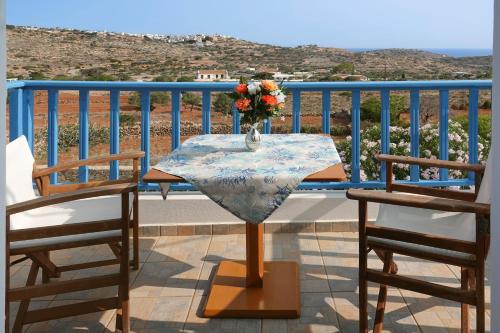 a table with a vase of flowers on a balcony at Aeriko Hotel Apartments in Arvanitochori