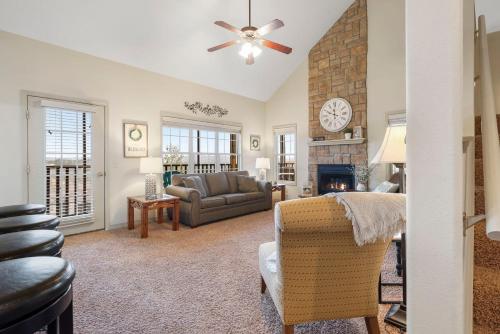 a living room with a couch and a fireplace at The Gathering Place - Minutes to 61-Acre Theme Park in Branson West