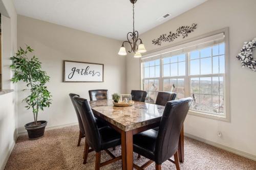 a dining room with a table and chairs at The Gathering Place - Minutes to 61-Acre Theme Park in Branson West