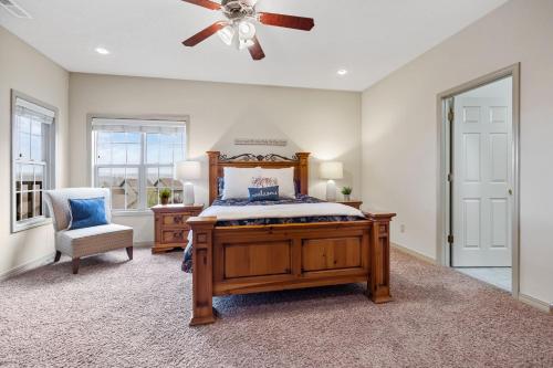 a bedroom with a bed and a ceiling fan at The Gathering Place - Minutes to 61-Acre Theme Park in Branson West