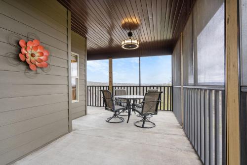 a patio with a table and chairs on a balcony at The Gathering Place - Minutes to 61-Acre Theme Park in Branson West