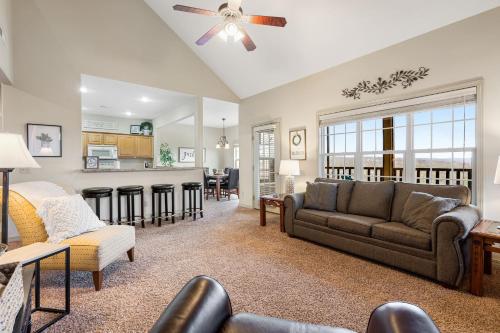 a living room with a couch and a kitchen at The Gathering Place - Minutes to 61-Acre Theme Park in Branson West