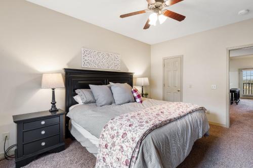 a bedroom with a bed and a ceiling fan at The Gathering Place - Minutes to 61-Acre Theme Park in Branson West