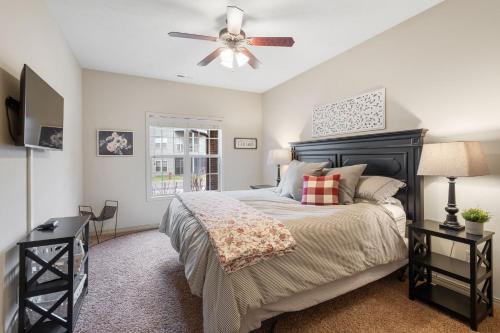 a bedroom with a bed and a ceiling fan at The Gathering Place - Minutes to 61-Acre Theme Park in Branson West